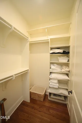 a view of walk in closet with empty racks
