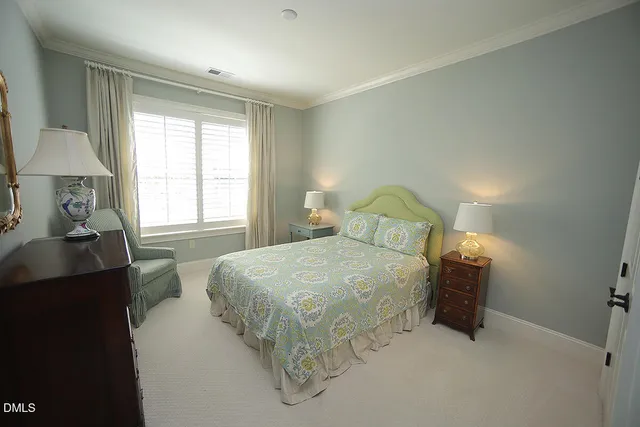 a bedroom with a bed and a table