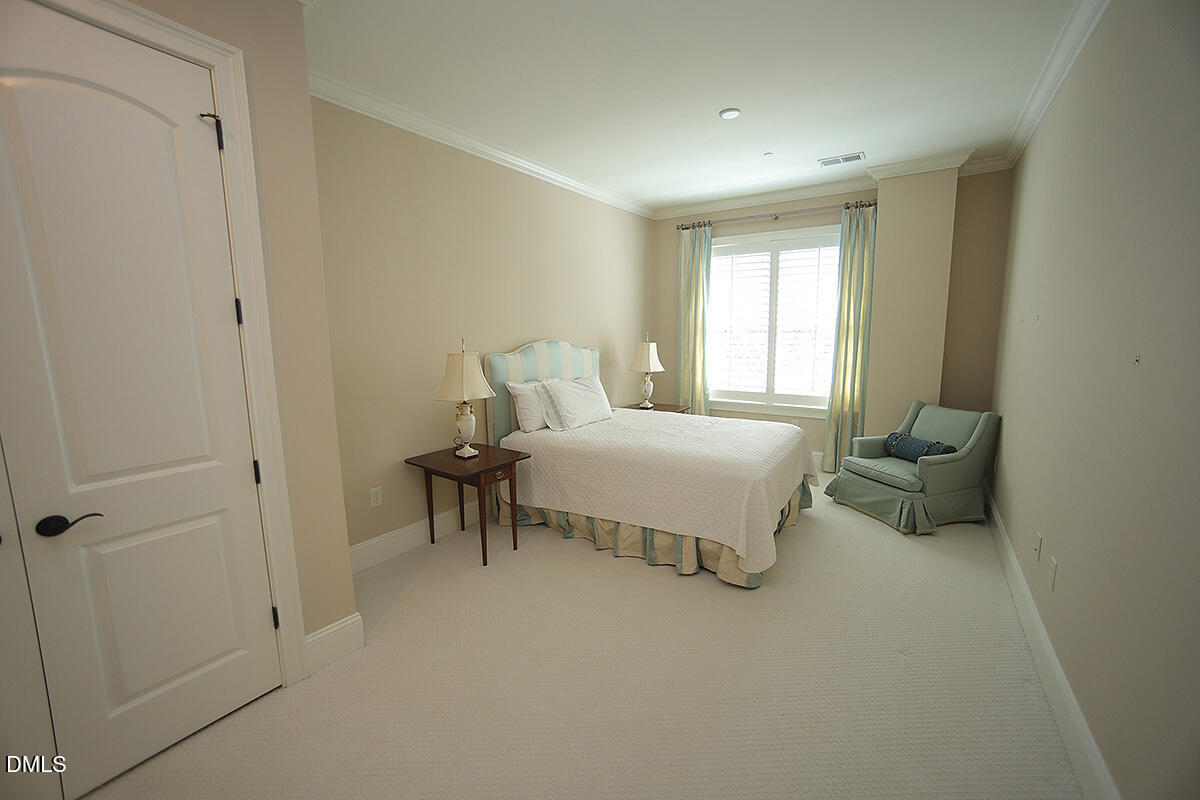 620 Wade Avenue, Unit 206 Raleigh, NC 27605 - Photo 40 of 42 a bedroom with a bed and a table