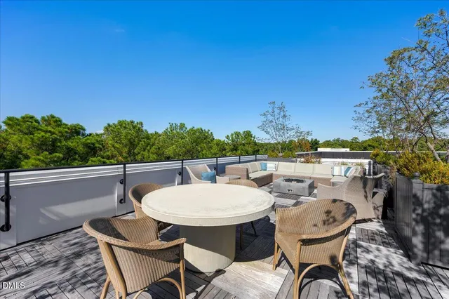 a balcony with table and chairs