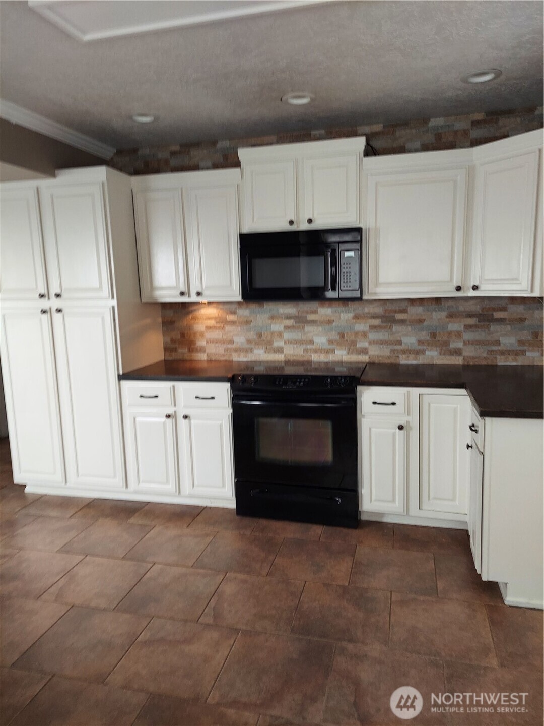 405 Strand Road Ephrata, WA 98823 - Photo 14 of 26 a kitchen with granite countertop a stove sink and cabinets