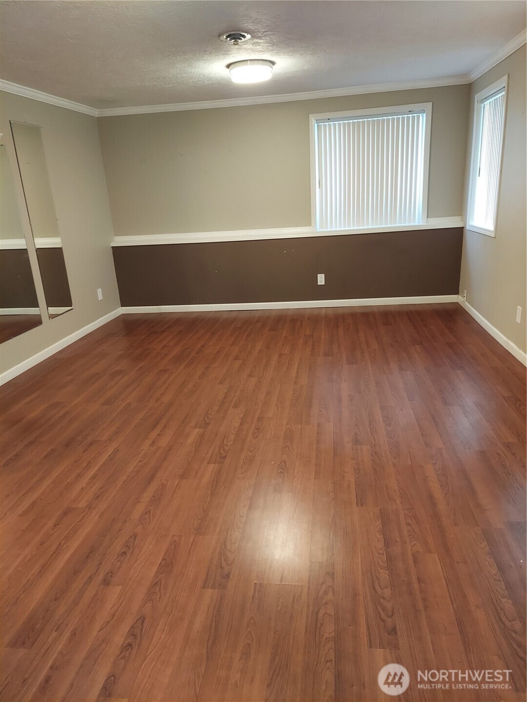 405 Strand Road Ephrata, WA 98823 - Photo 7 of 26 an empty room with wooden floor and windows