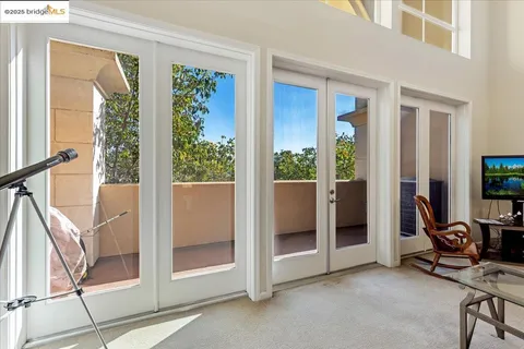 a view of a livingroom with furniture and floor to ceiling window