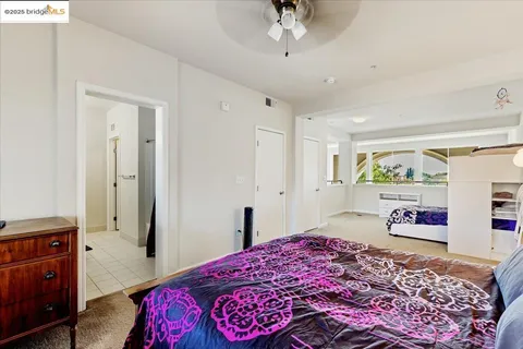 a bedroom with a bed dresser and a window