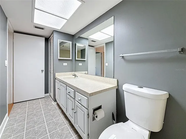 an aerial view of a house with a garden and lake view