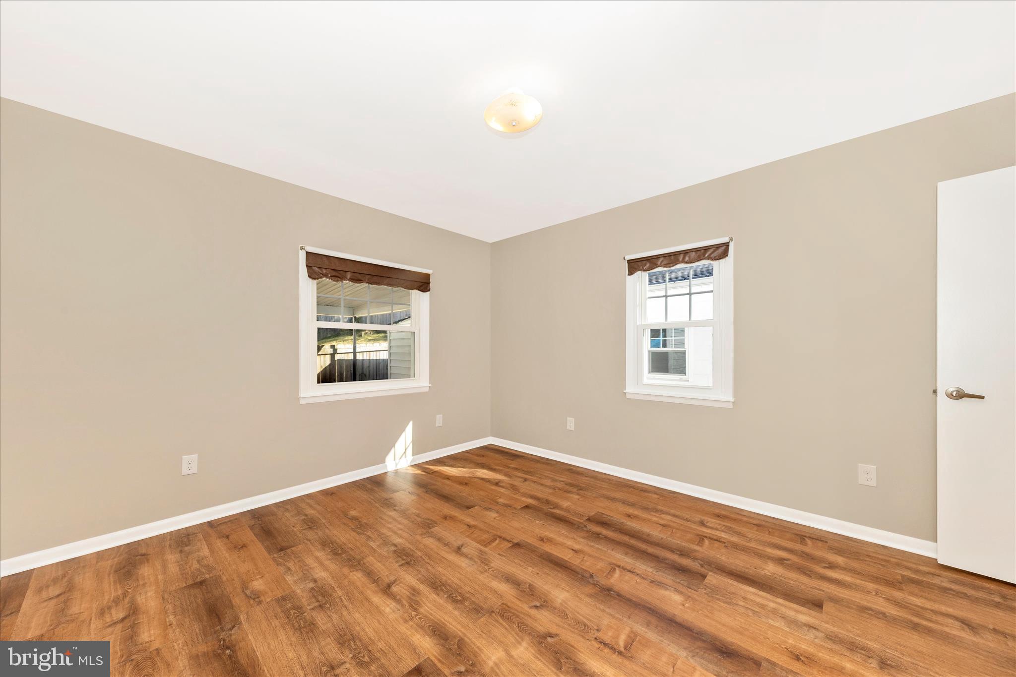 4410 Fernhill Road Silver Spring, MD 20906 - Photo 12 of 49 a view of a big room with wooden floor and windows
