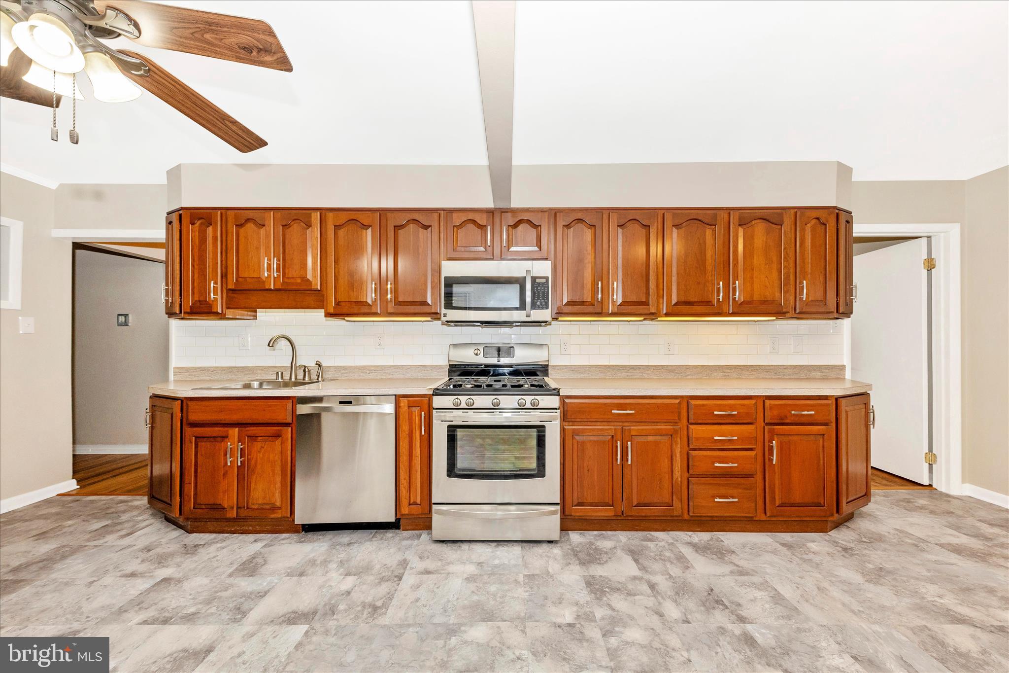 4410 Fernhill Road Silver Spring, MD 20906 - Photo 6 of 49 a kitchen with stainless steel appliances granite countertop a stove top oven a sink and dishwasher