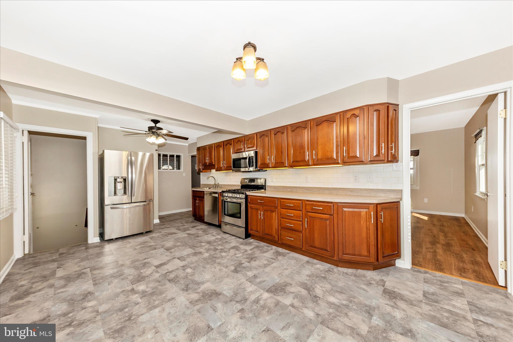 4410 Fernhill Road Silver Spring, MD 20906 - Photo 7 of 49 a kitchen with stainless steel appliances a stove top oven a sink and dishwasher