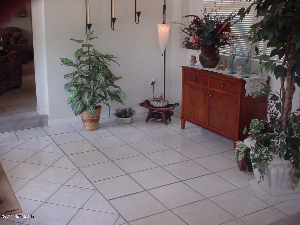 4527 Manchester Road Jacksonville, FL 32210 - Photo 6 of 20 a view of a potted plants and dinning table in a backyard