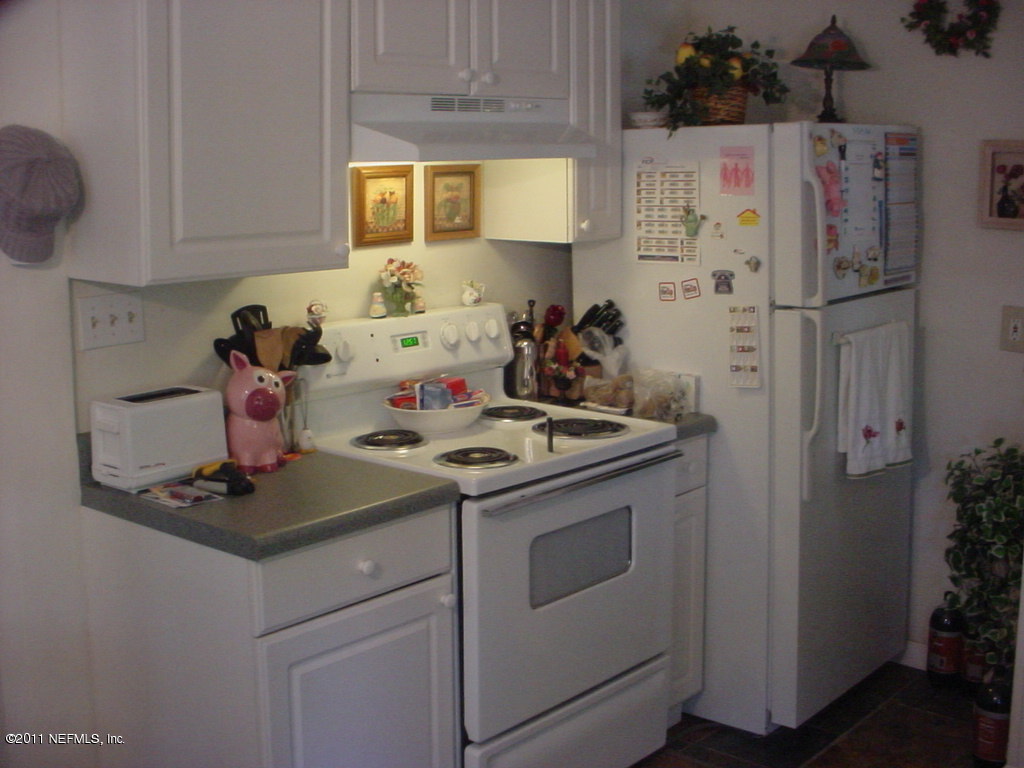 4527 Manchester Road Jacksonville, FL 32210 - Photo 10 of 20 a kitchen with stainless steel appliances a stove and a refrigerator