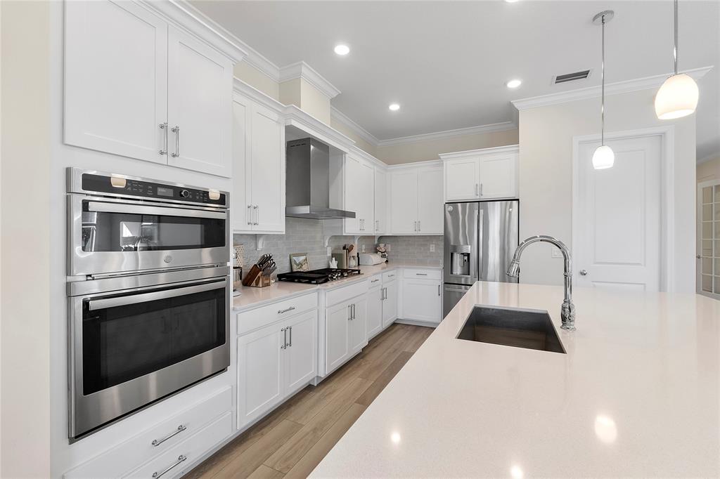 1131 Chisel Plow Chase Loxahatchee, FL 33470 - Photo 25 of 72 a kitchen with white cabinets stainless steel appliances and sink
