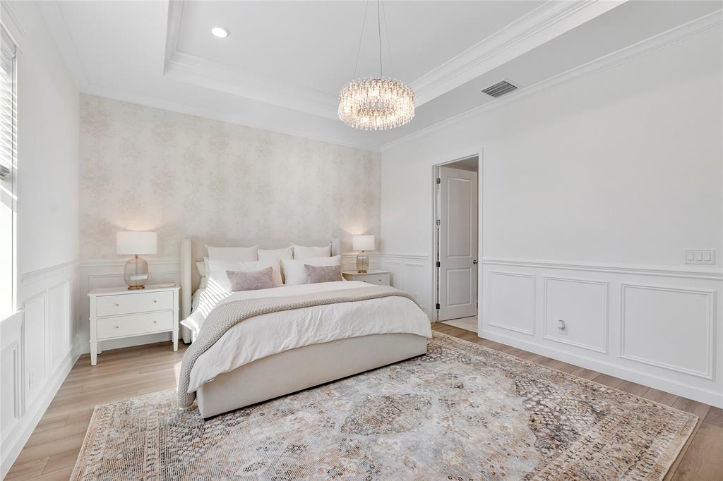 1131 Chisel Plow Chase Loxahatchee, FL 33470 - Photo 33 of 72 a spacious bedroom with a bed and a chandelier