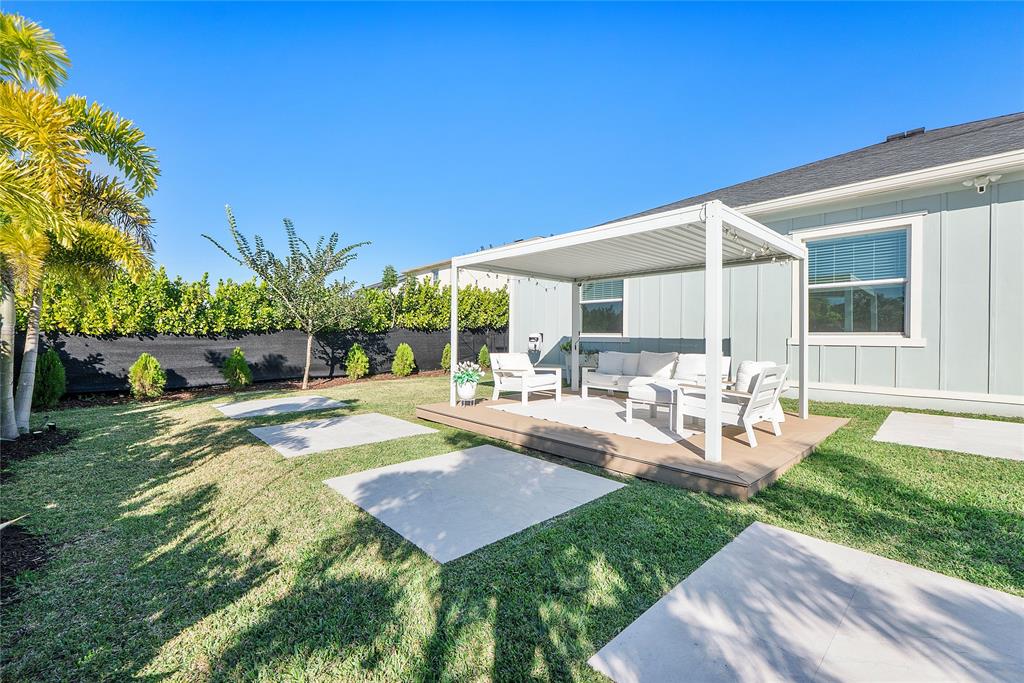 1131 Chisel Plow Chase Loxahatchee, FL 33470 - Photo 59 of 72 a view of a backyard with sitting area