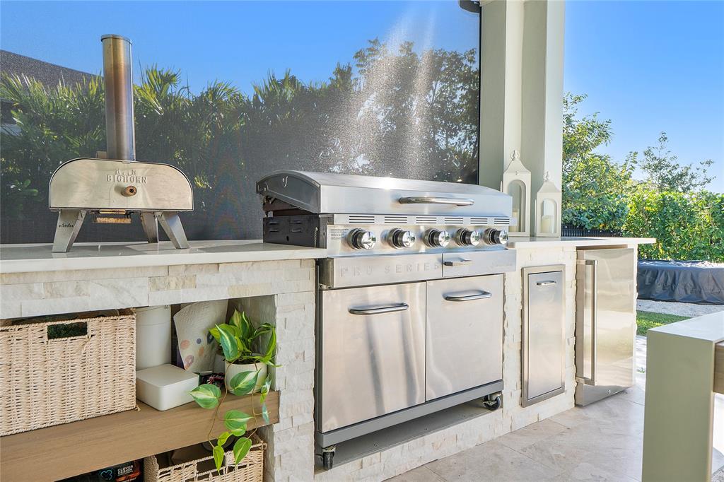 1131 Chisel Plow Chase Loxahatchee, FL 33470 - Photo 64 of 72 a kitchen with stainless steel appliances kitchen island granite countertop a table and chairs