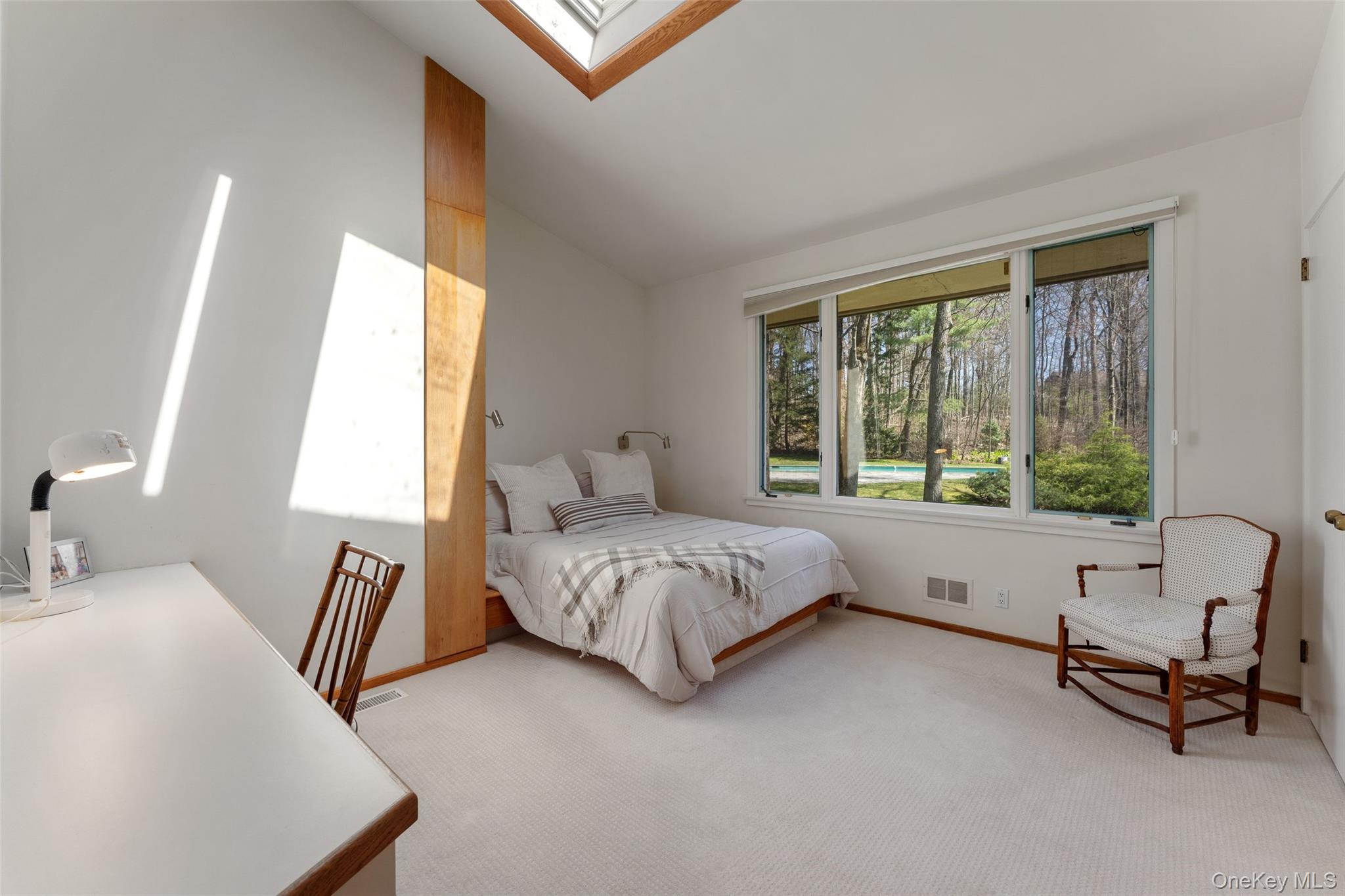98 Cushman Road Scarsdale, NY 10583 - Photo 27 of 43 a spacious bedroom with a bed and a large window