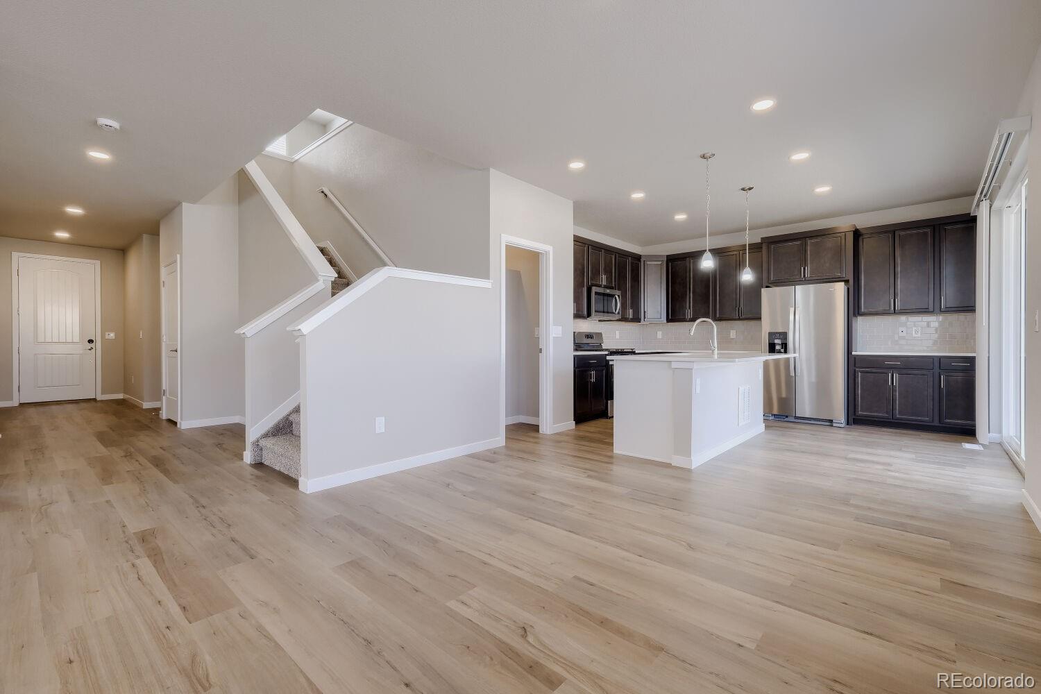 471 Atchison Way Calhan, CO 80808 - Photo 12 of 31 a view of a kitchen with a sink and a refrigerator