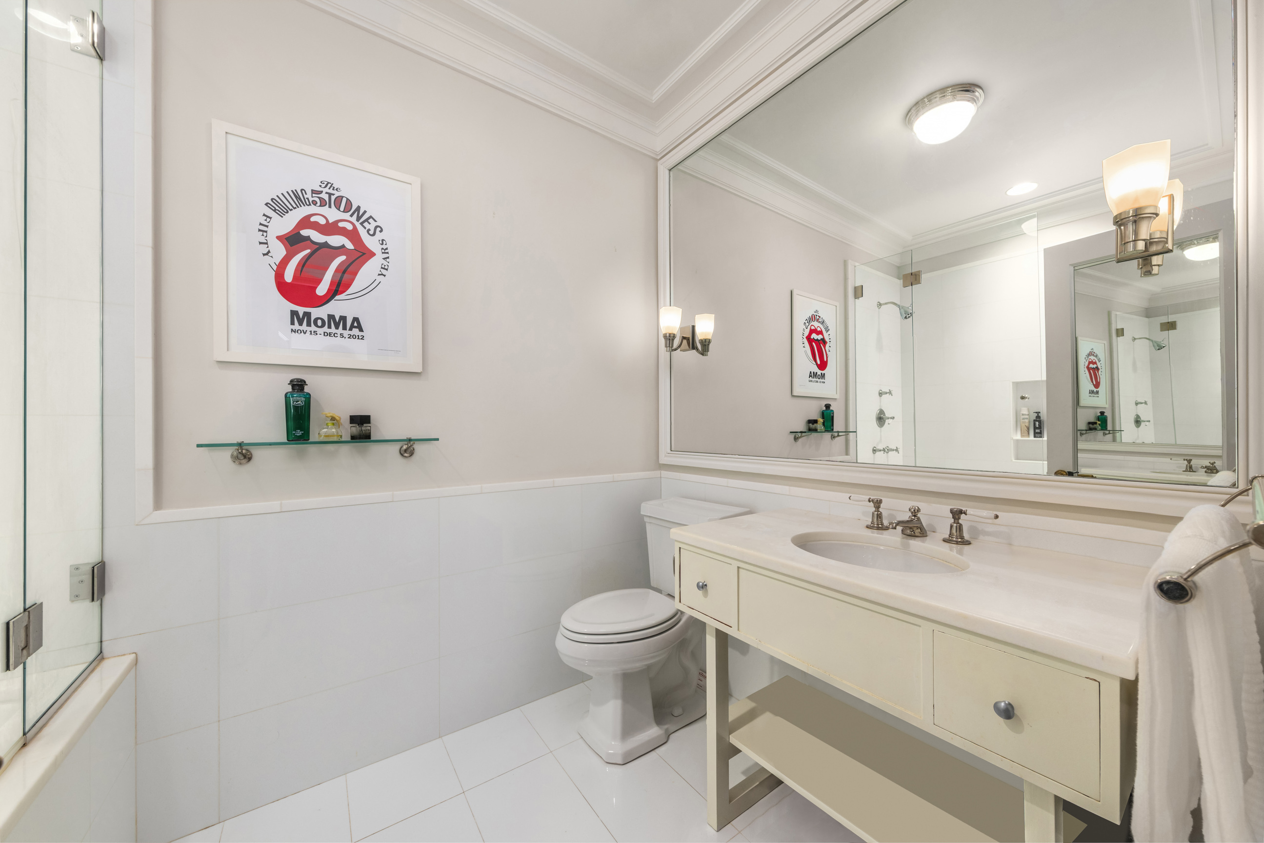 Undisclosed Address Manhattan, NY 10021 - Photo 16 of 25 a bathroom with a sink a toilet and a mirror