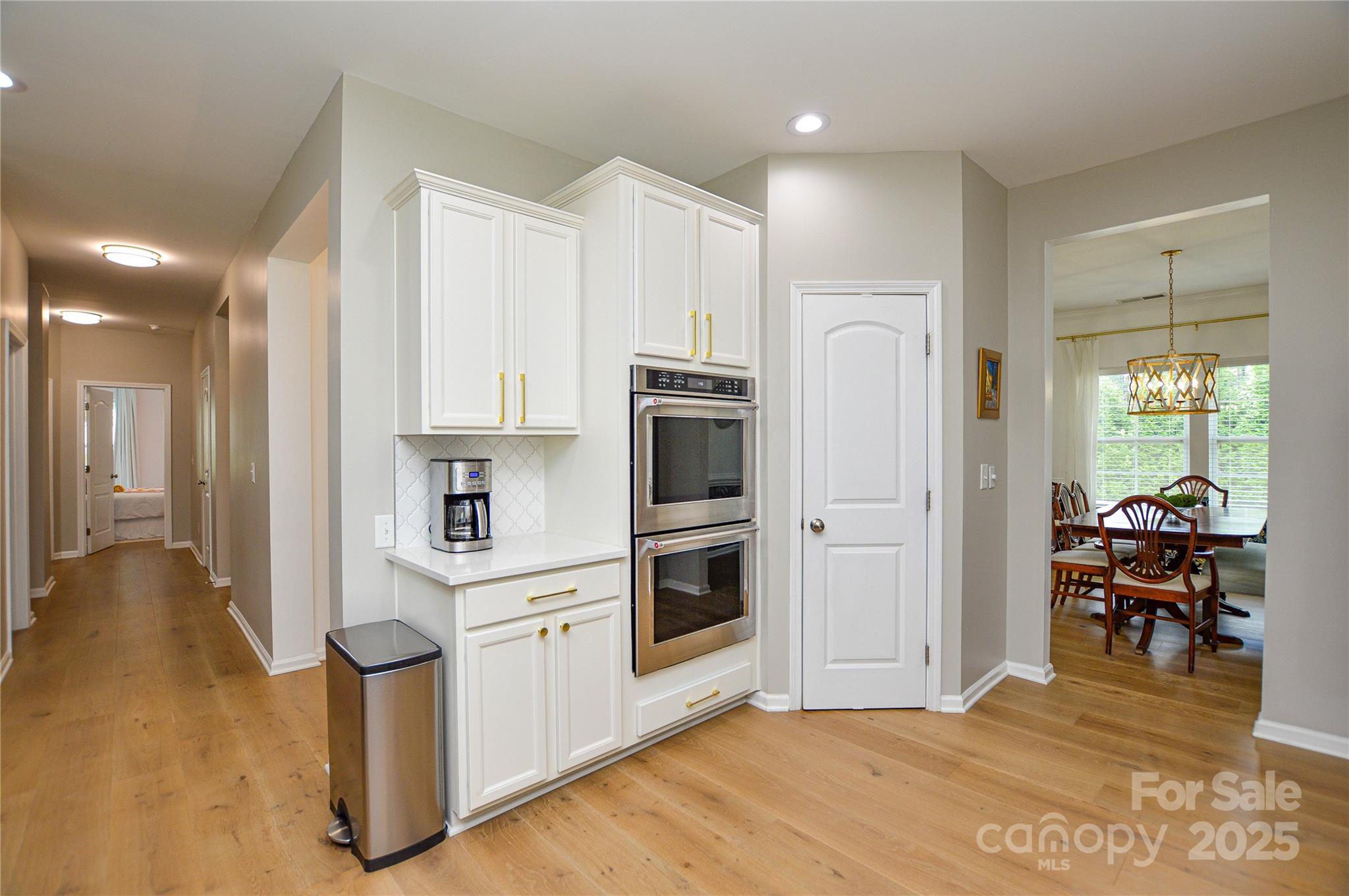 86506 Arrington Road Lancaster, SC 29720 - Photo 13 of 48 a kitchen with stainless steel appliances white cabinets and wooden floors