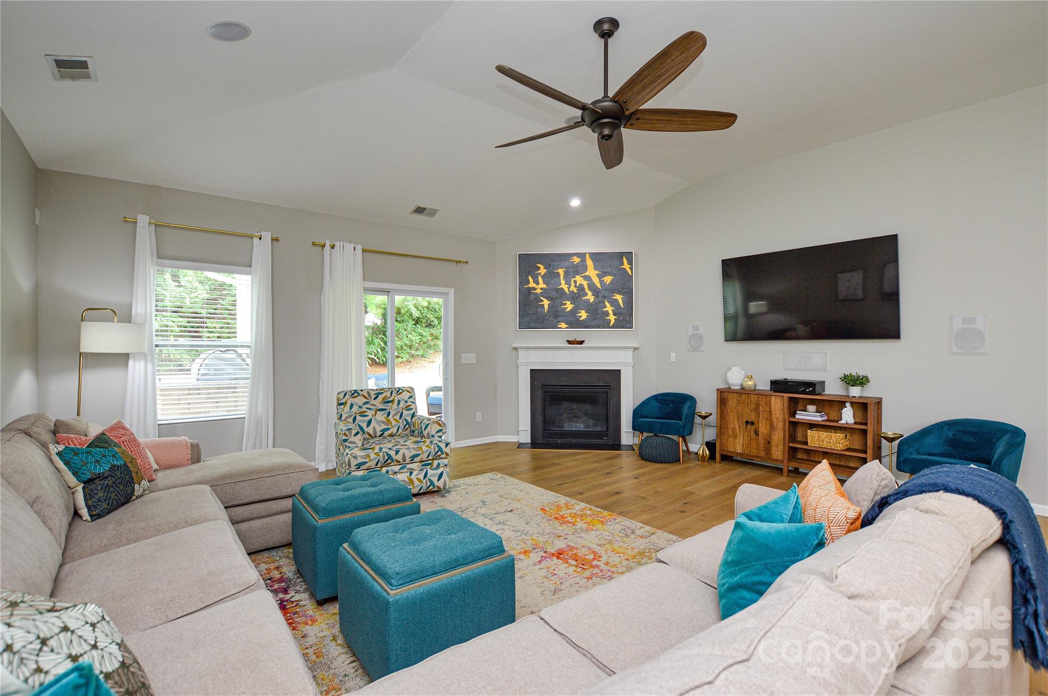 86506 Arrington Road Lancaster, SC 29720 - Photo 19 of 48 a living room with furniture a fireplace and a flat screen tv