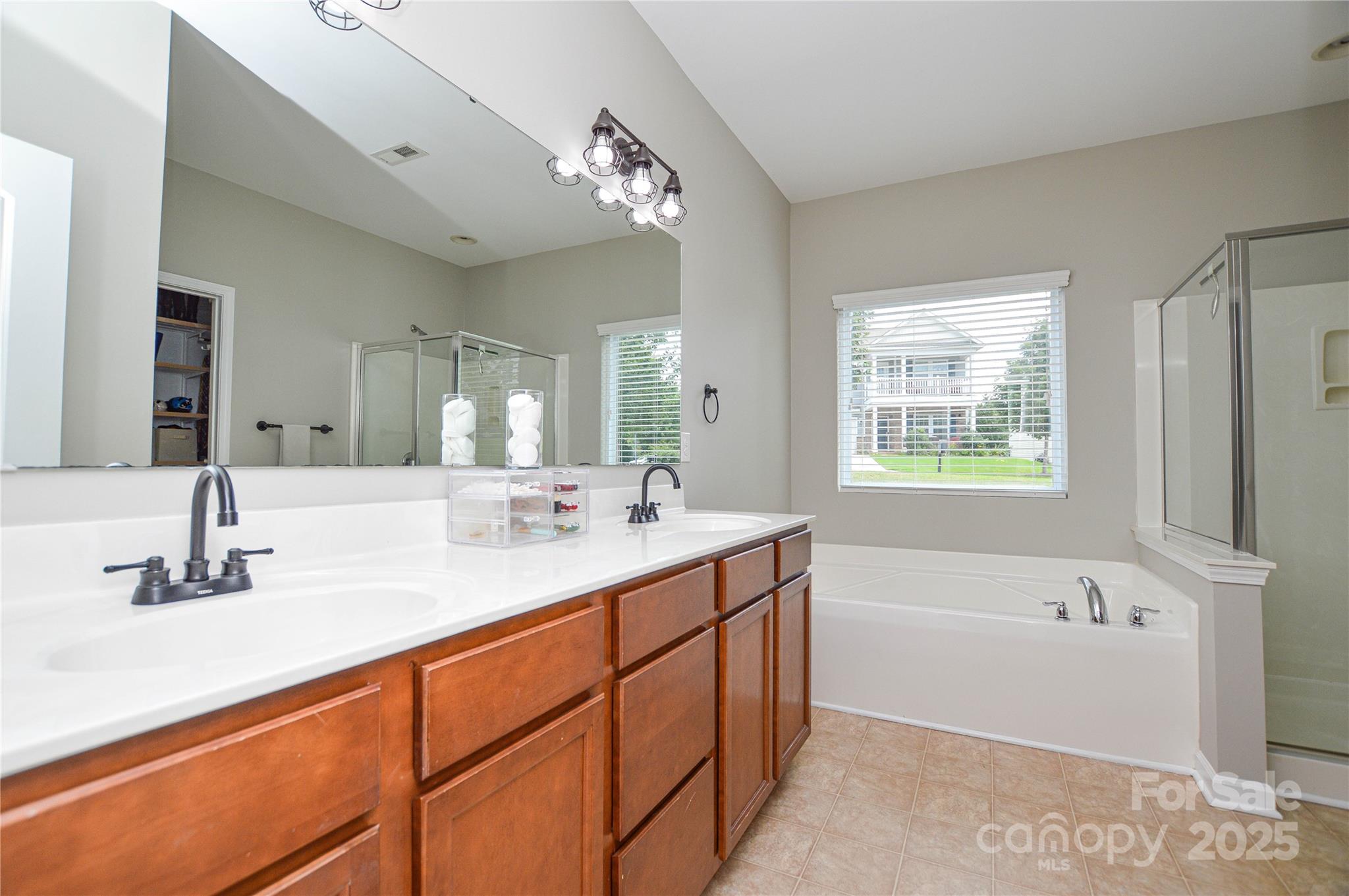 86506 Arrington Road Lancaster, SC 29720 - Photo 27 of 48 a bathroom with a tub sink and mirror