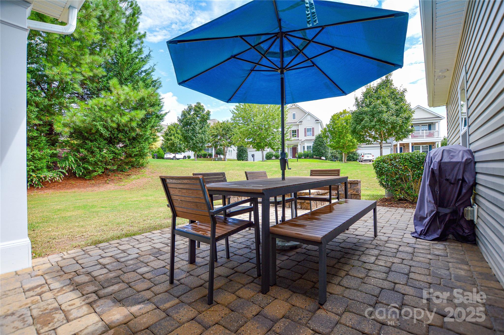 86506 Arrington Road Lancaster, SC 29720 - Photo 44 of 48 a view of a patio with a table chairs and a umbrella