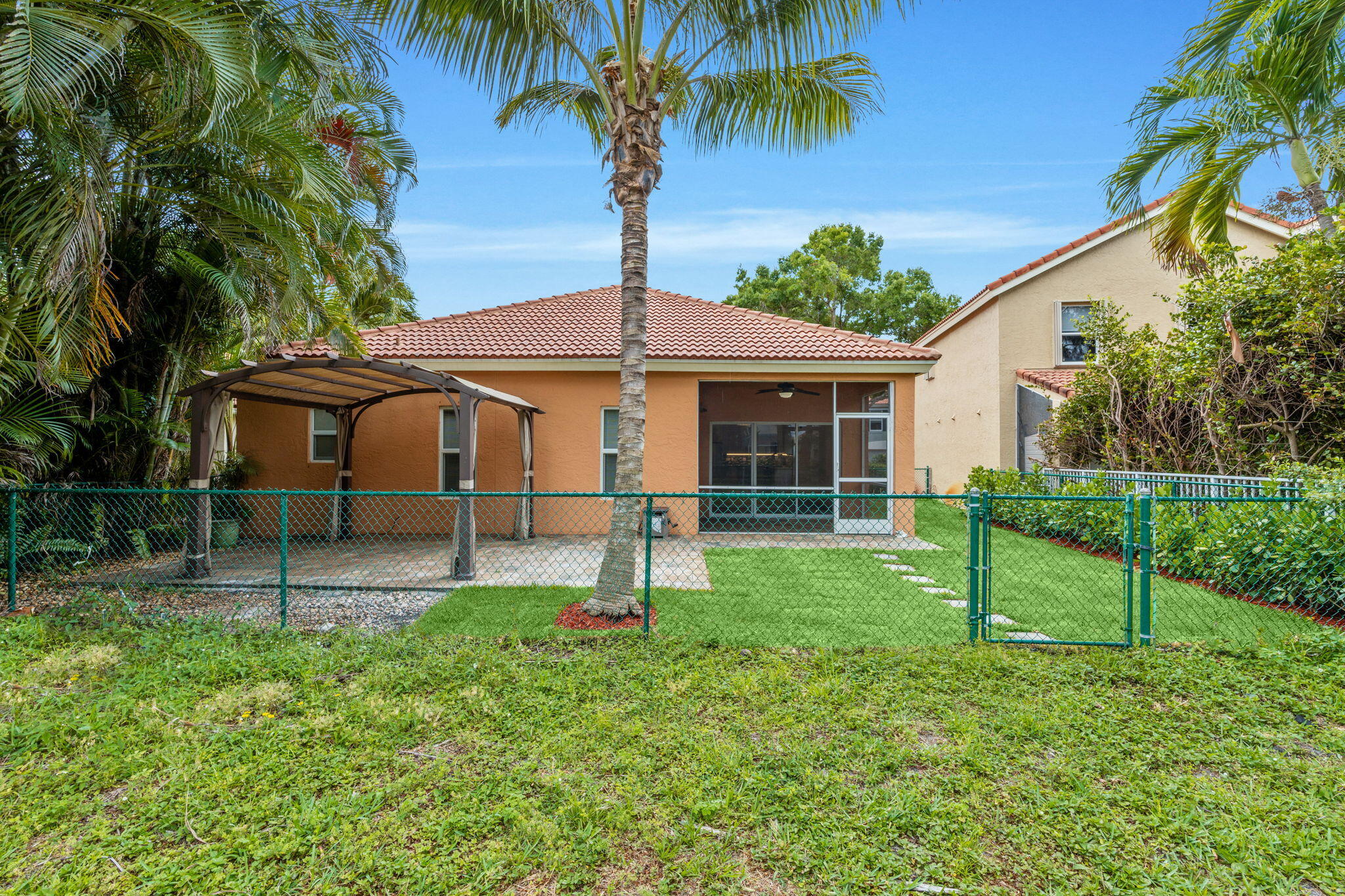 5122 Elpine Way Riviera Beach, FL 33418 - Photo 14 of 35 a view of a house with a yard and a garden