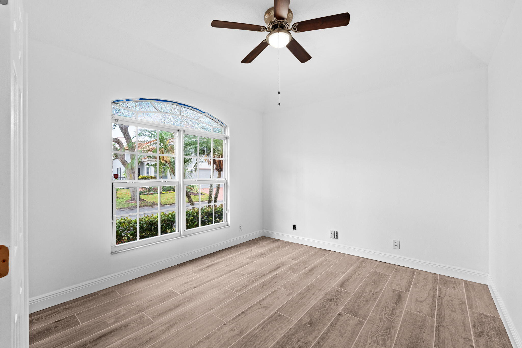 5122 Elpine Way Riviera Beach, FL 33418 - Photo 15 of 35 an empty room with a window and a view of kitchen