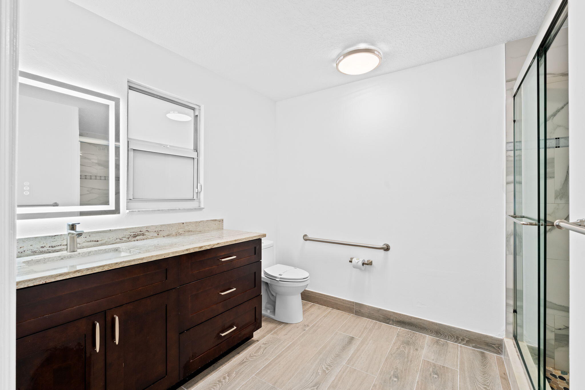 5122 Elpine Way Riviera Beach, FL 33418 - Photo 21 of 35 a bathroom with a double vanity sink toilet and a mirror