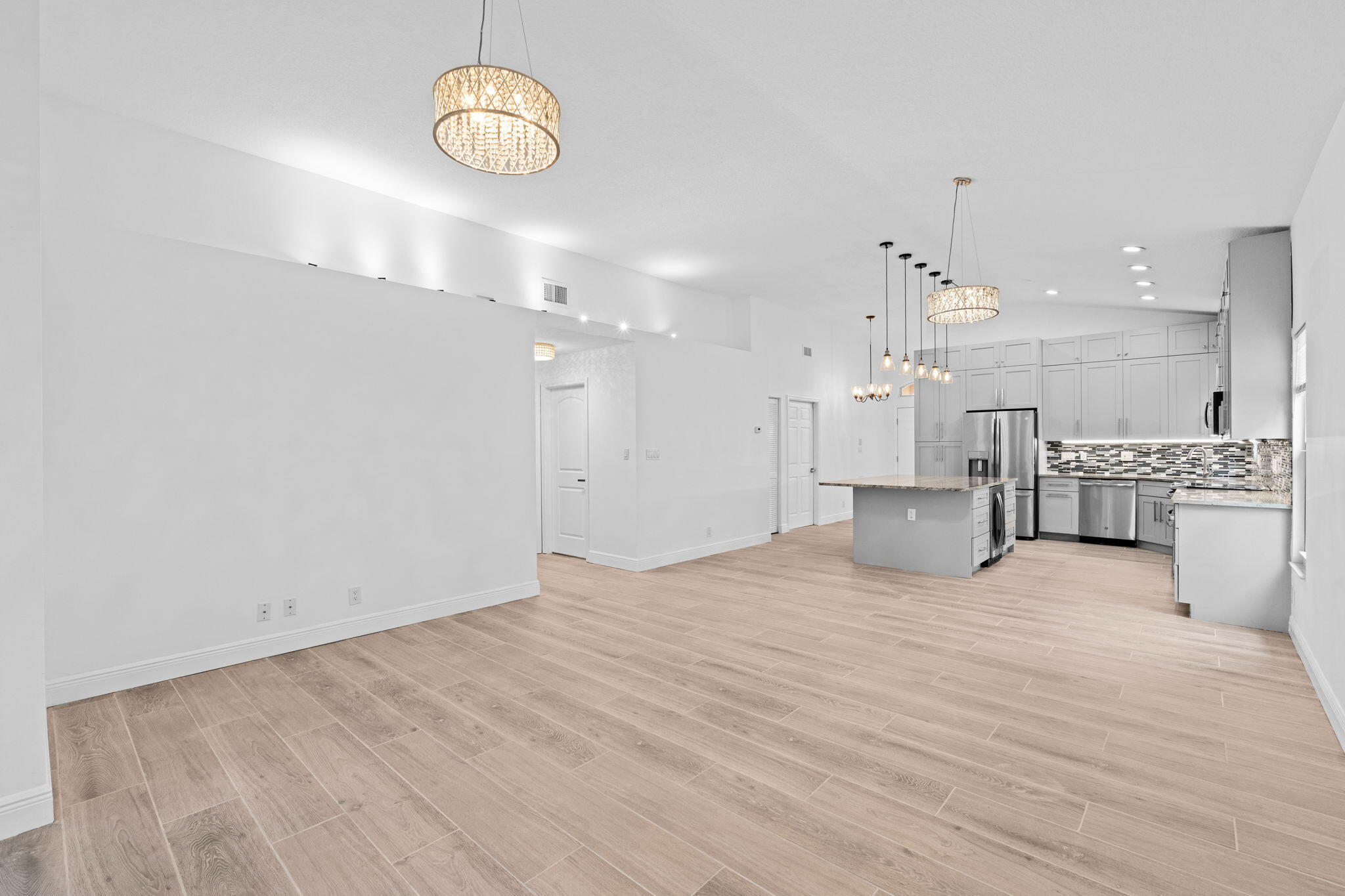 5122 Elpine Way Riviera Beach, FL 33418 - Photo 23 of 35 a view of an empty room with a kitchen