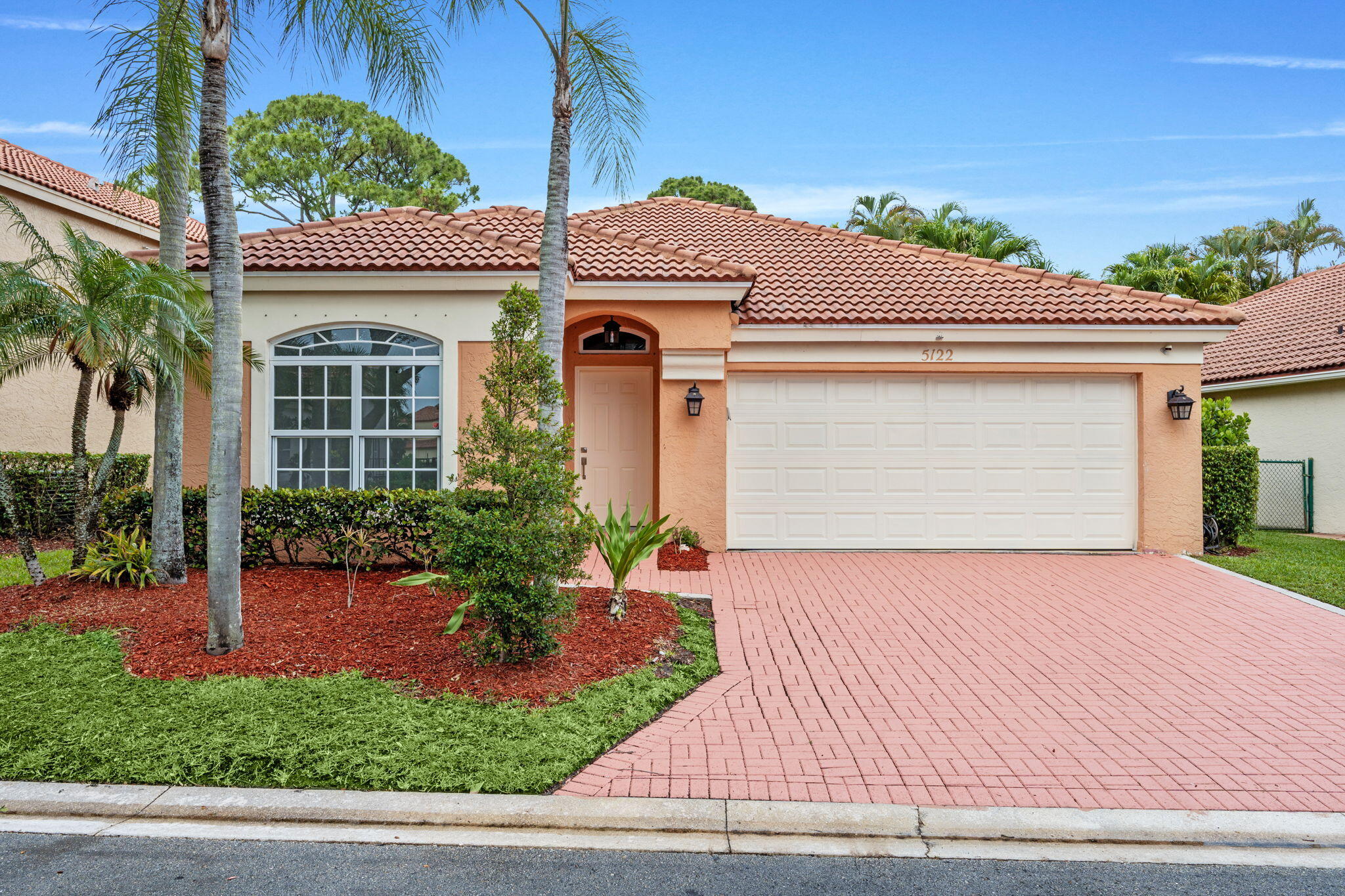 5122 Elpine Way Riviera Beach, FL 33418 - Photo 24 of 35 a front view of a house with a garden