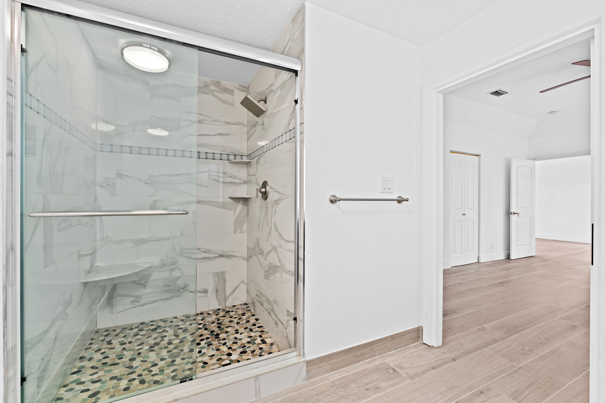5122 Elpine Way Riviera Beach, FL 33418 - Photo 26 of 35 a bathroom with a glass shower door