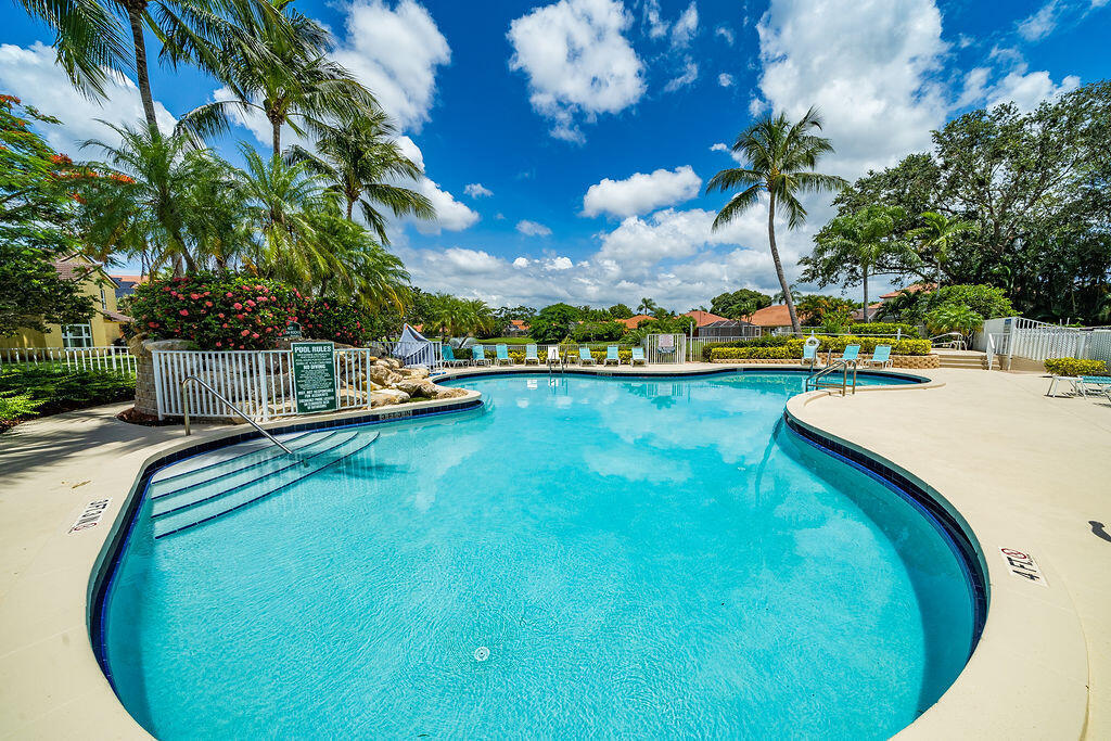 5122 Elpine Way Riviera Beach, FL 33418 - Photo 32 of 35 a view of a swimming pool with an outdoor seating and yard
