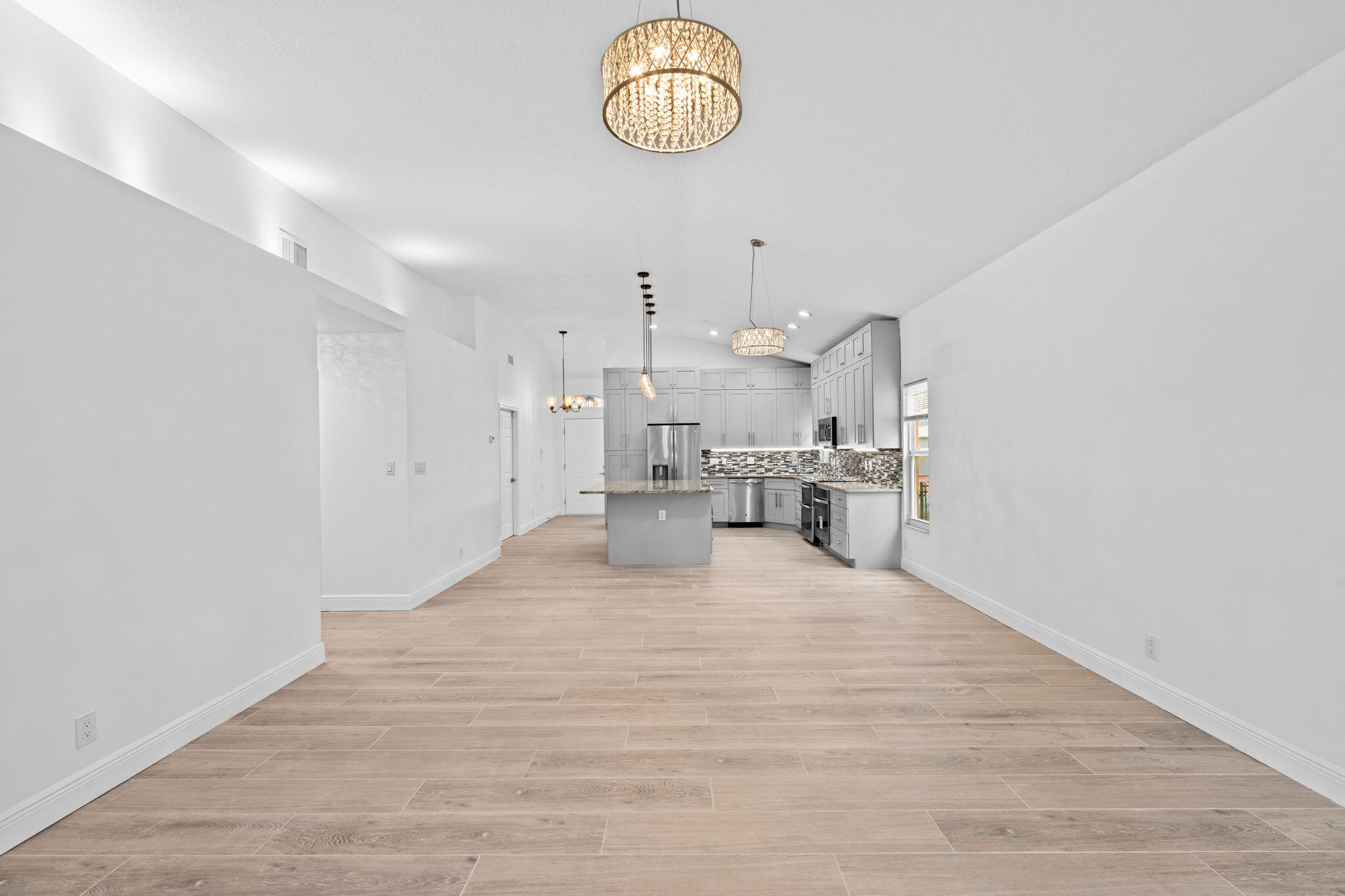 5122 Elpine Way Riviera Beach, FL 33418 - Photo 6 of 35 a view of kitchen and hall with wooden floor