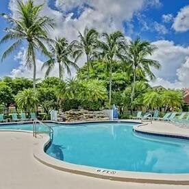 5122 Elpine Way Riviera Beach, FL 33418 - Photo 7 of 35 a view of a swimming pool with a yard