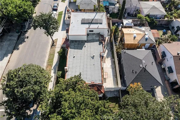 an aerial view of a residential apartment building with a yard