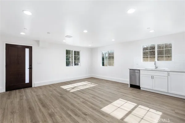 a view of a big room with windows and cabinet