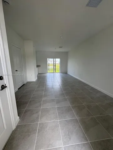 a view of an empty room and a window