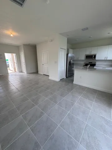 a view of a livingroom with furniture and a window