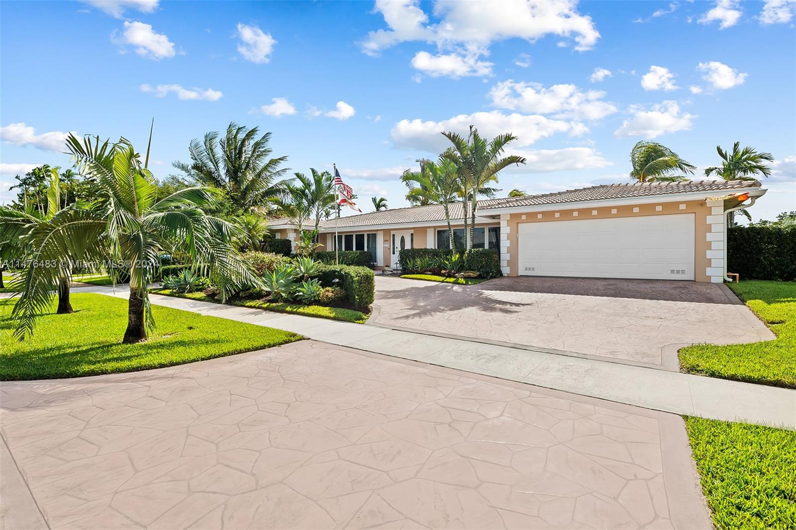 a front view of a house with a yard and trees