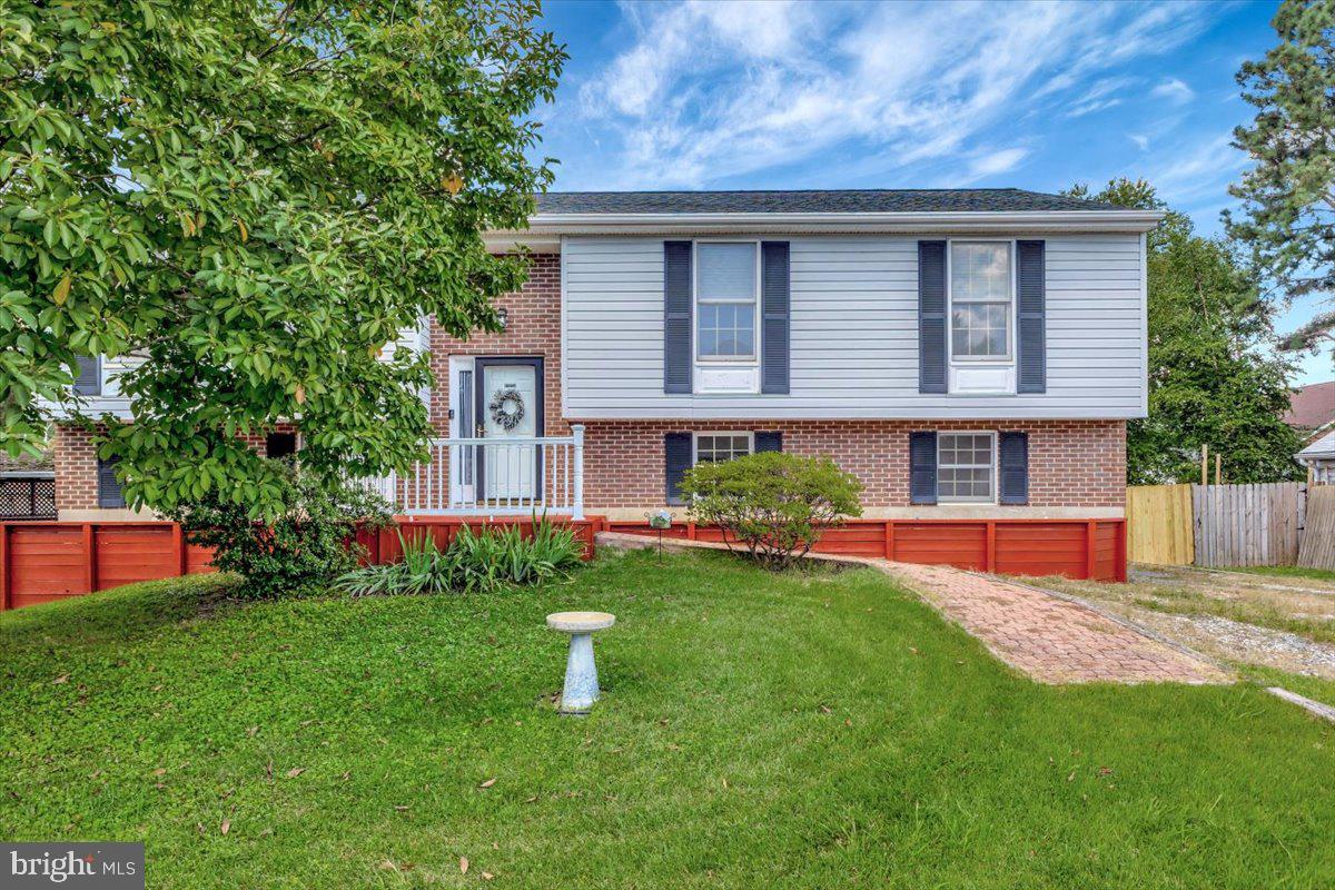 a front view of house with yard and outdoor seating