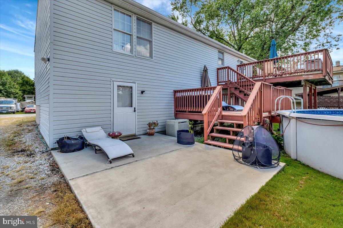 13226 Susquehanna Road Baltimore, MD 21220 - Photo 12 of 43 a backyard of a house with barbeque oven and outdoor seating