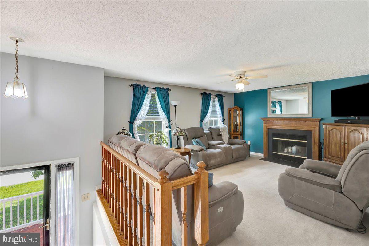 13226 Susquehanna Road Baltimore, MD 21220 - Photo 13 of 43 a living room with fireplace furniture and a flat screen tv