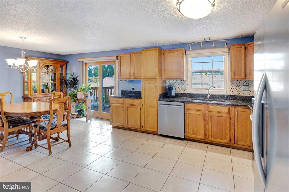 13226 Susquehanna Road Baltimore, MD 21220 - Photo 18 of 43 a kitchen with stainless steel appliances kitchen island granite countertop a sink and cabinets