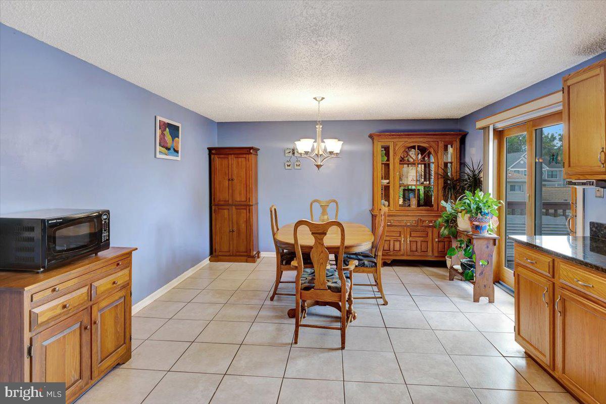 13226 Susquehanna Road Baltimore, MD 21220 - Photo 19 of 43 a living room with furniture a flat screen tv and a dining table