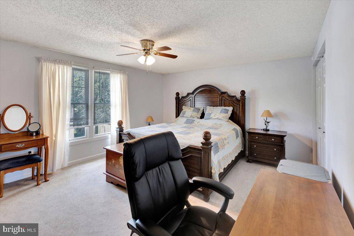 13226 Susquehanna Road Baltimore, MD 21220 - Photo 22 of 43 a bedroom with a bed and a chandelier