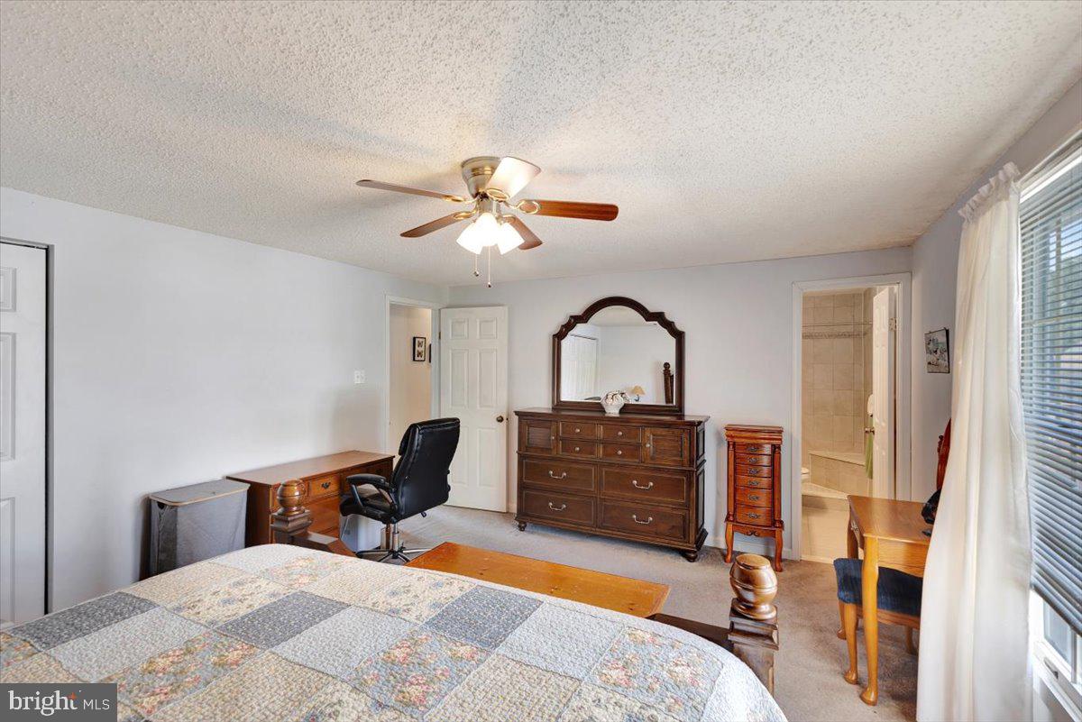 13226 Susquehanna Road Baltimore, MD 21220 - Photo 24 of 43 a bedroom with a bed and a chandelier