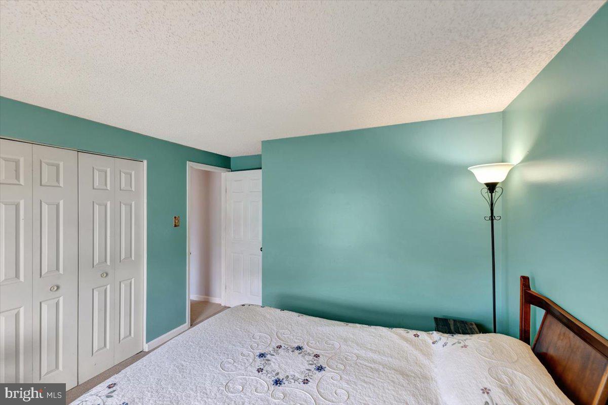 13226 Susquehanna Road Baltimore, MD 21220 - Photo 28 of 43 a bedroom with a bed and a chandelier