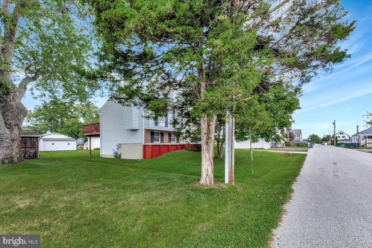 13226 Susquehanna Road Baltimore, MD 21220 - Photo 3 of 43 a view of a house with a big yard and large trees