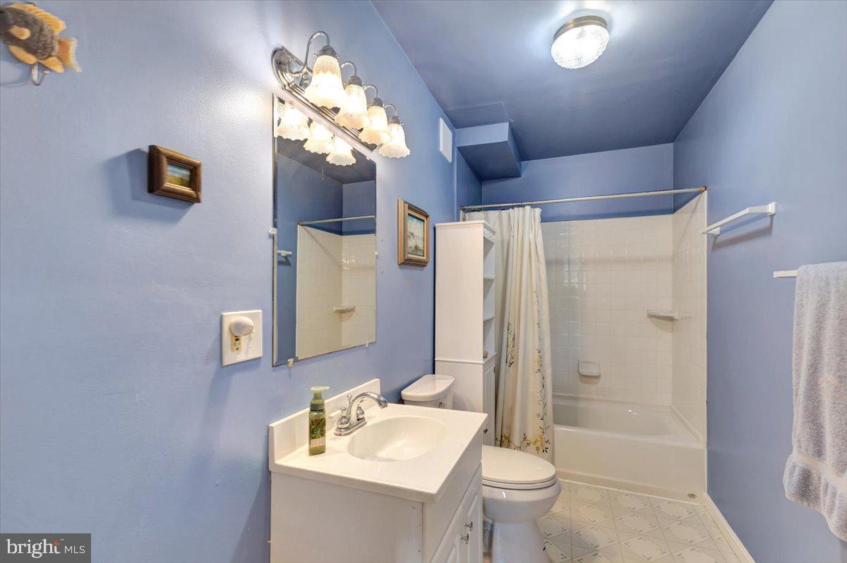 13226 Susquehanna Road Baltimore, MD 21220 - Photo 36 of 43 a bathroom with a sink a toilet and a mirror