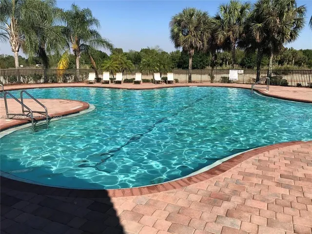 a view of a swimming pool with a patio